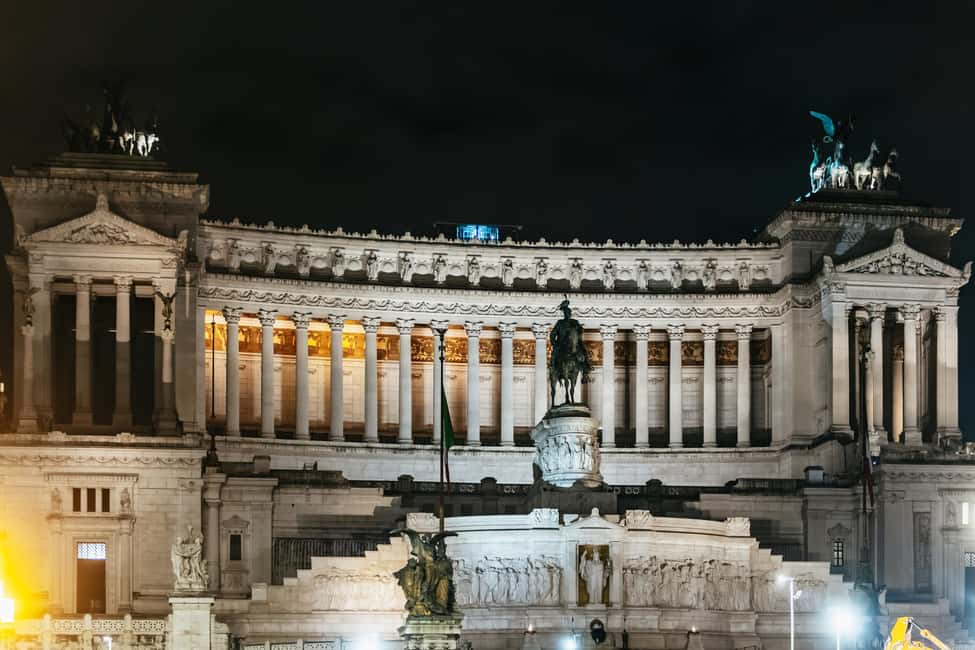 Rome: City Highlights Moonlight Walking Tour - Via dei Fori Imperiali and the Colosseum glow outside
